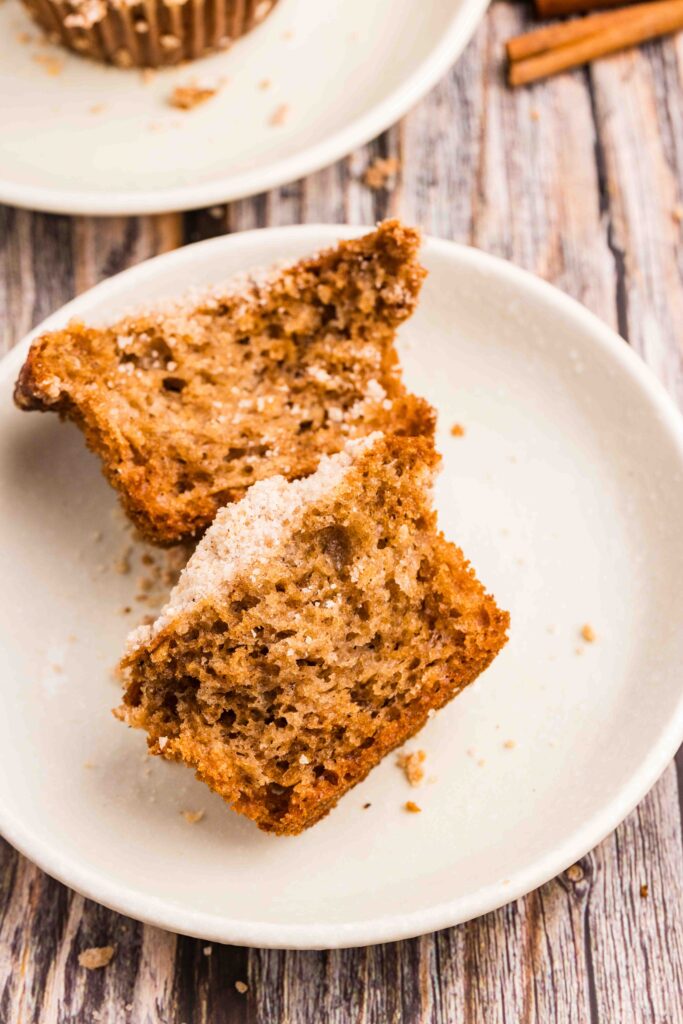 applesauce muffin split in half on a white plate